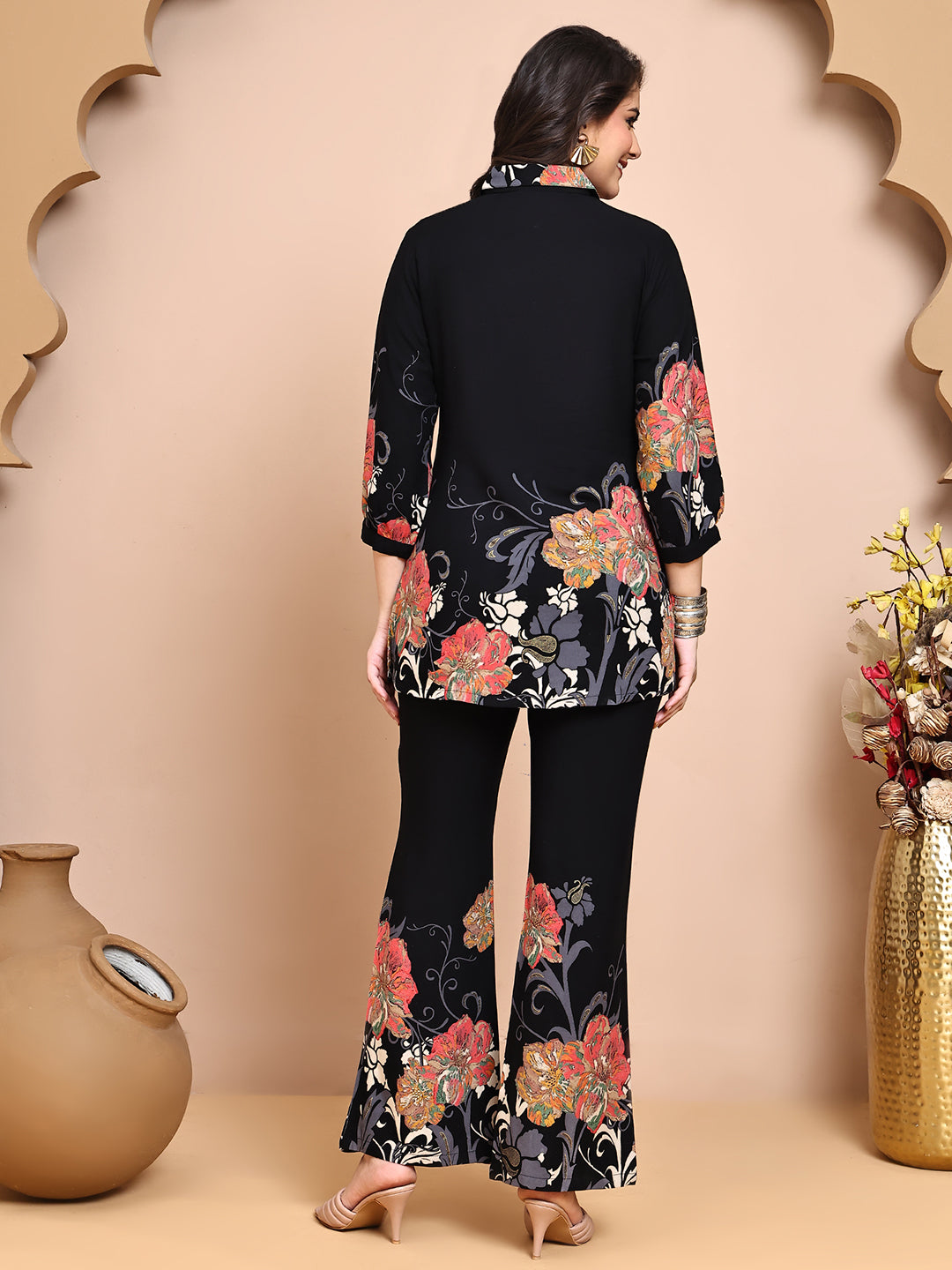 Back view of model styling black floral co-ord outfit