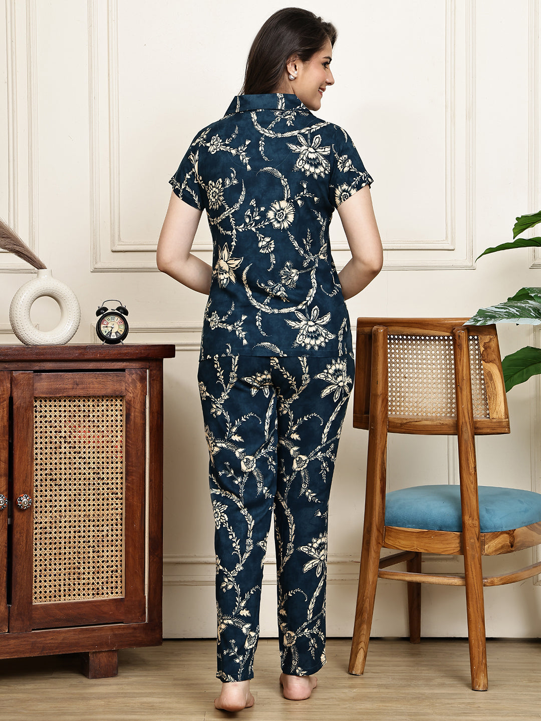 Back view of a model in the navy blue printed night suit