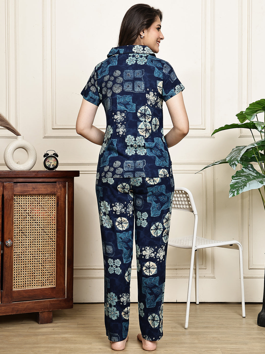 Back view of a model in a purple floral printed night suit