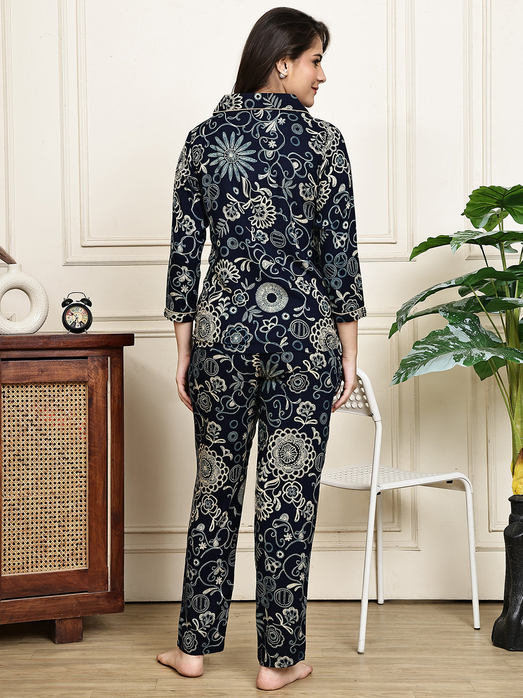 A woman lounging comfortably in the ethnic print night suit for women.