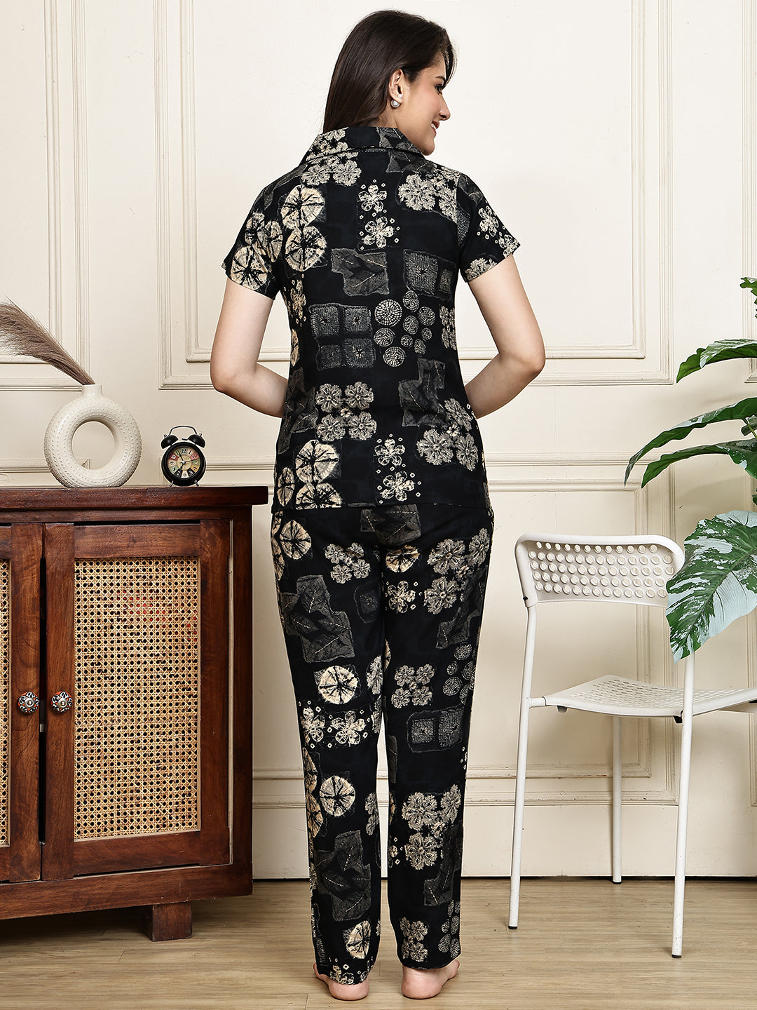 Back view of model wearing the black printed rayon night suit