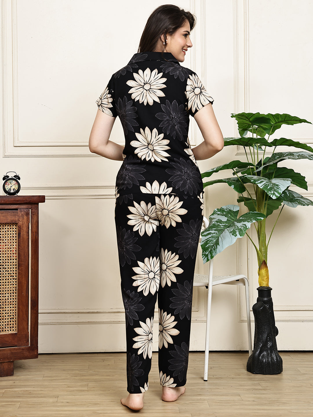 Back view of a model in the black floral printed night suit