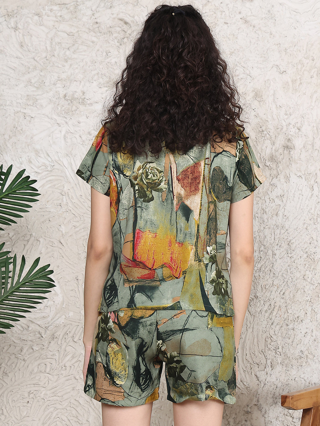 Back view of model in green printed night suit