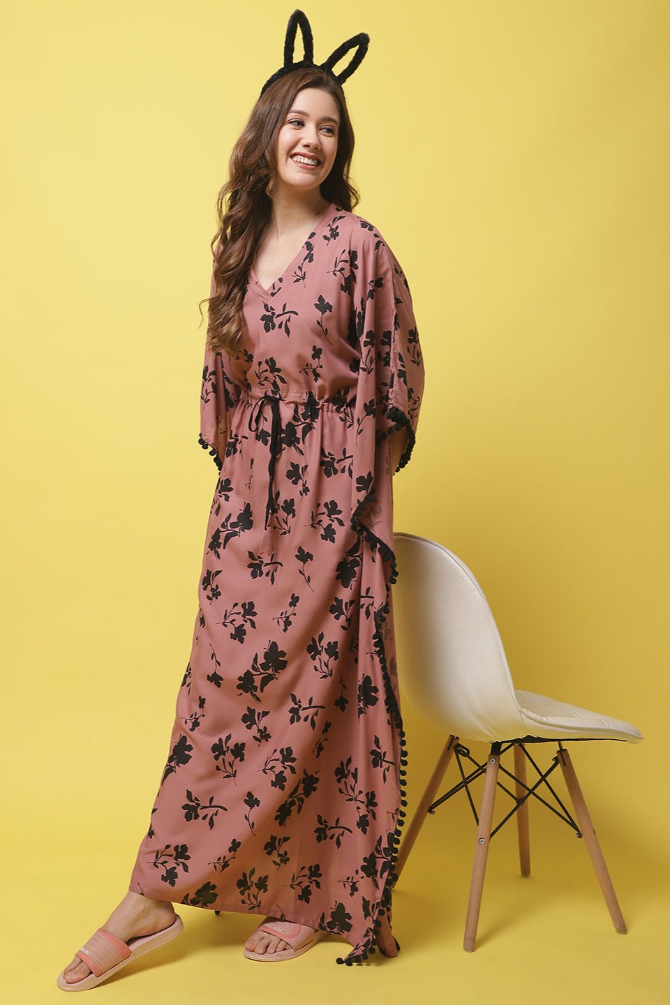 Woman wearing rust floral Kaftan Dress