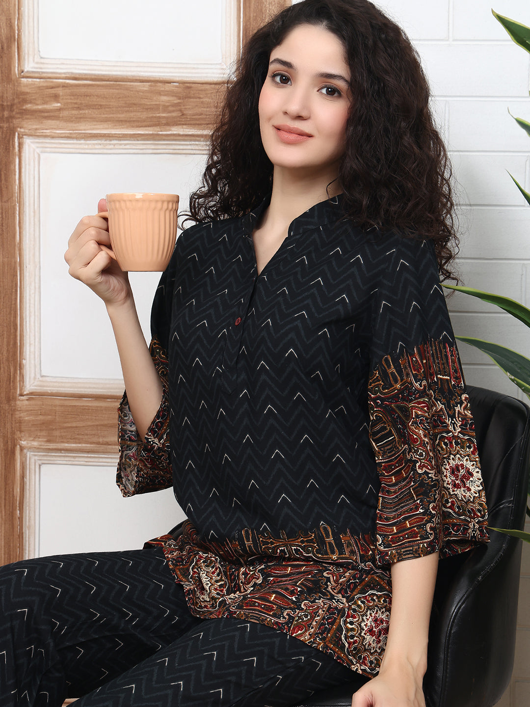 Close-up of black shirt top with mandarin collar and abstract pattern