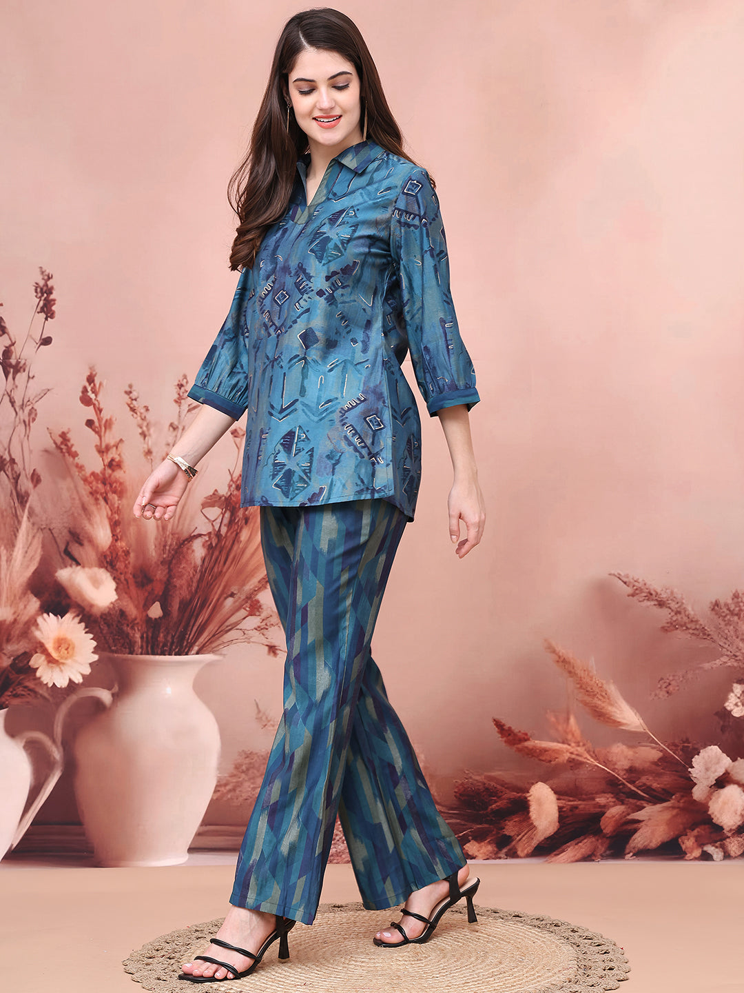 Back view of model styling blue co-ord outfit with three-quarter sleeves.