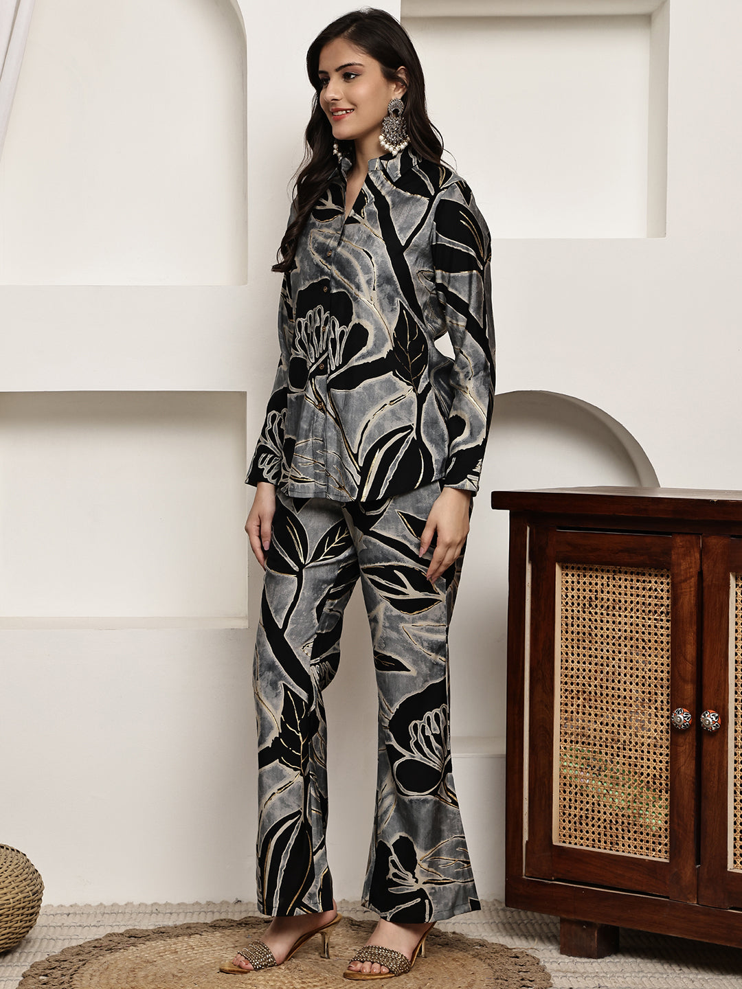 Side view of woman wearing the elegant black floral outfit