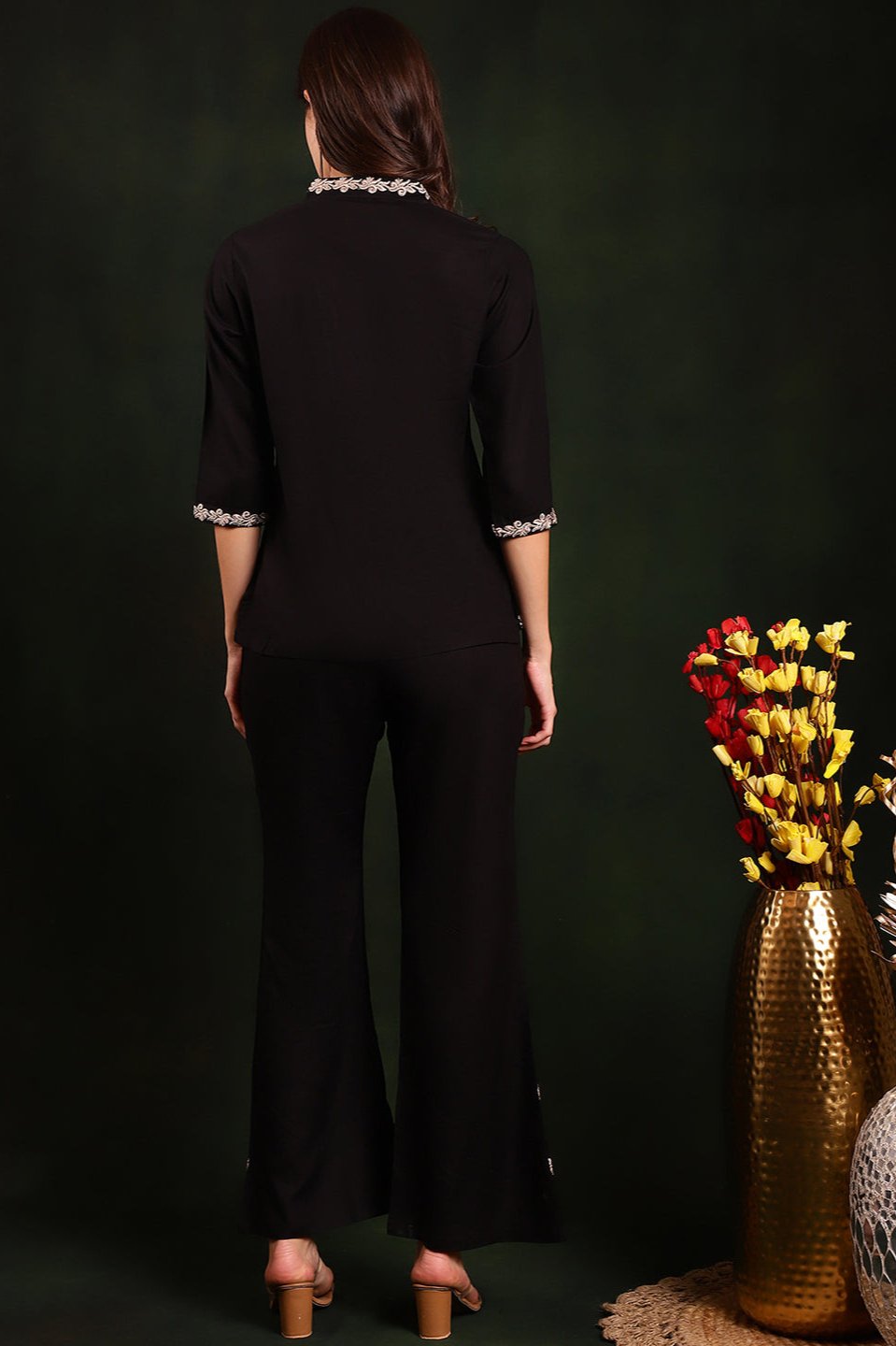 Back view of model styling black co-ord outfit