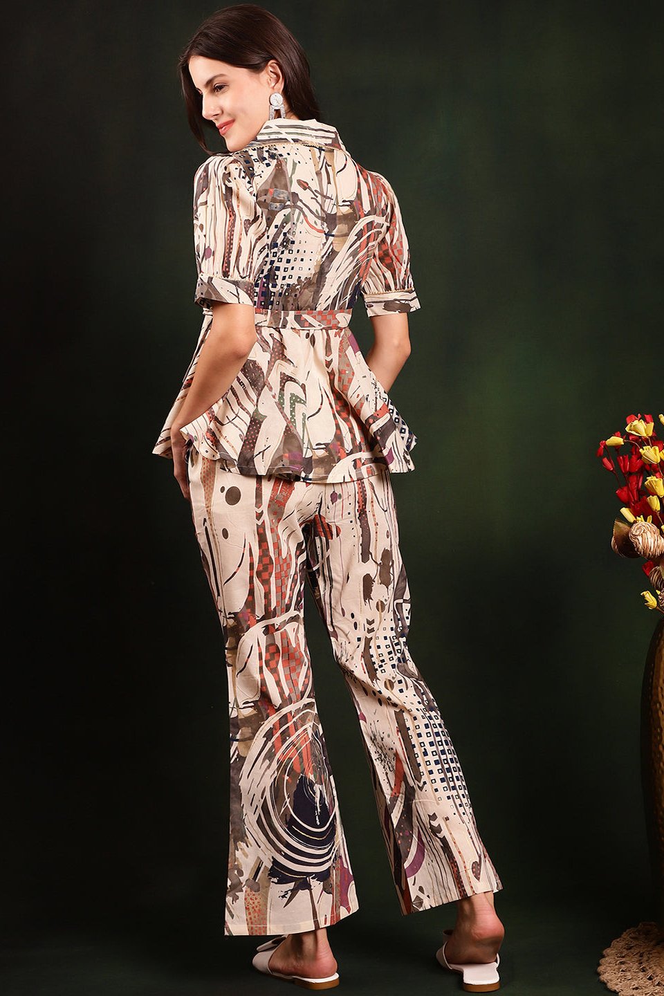 Back view of a model styling the cream printed co-ord outfit.
