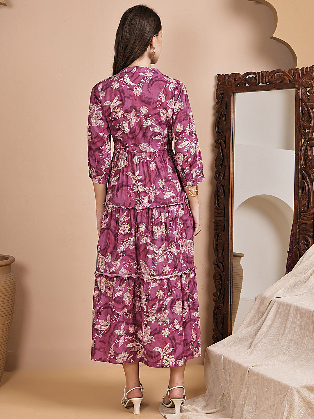 Back view of model in purple printed dress