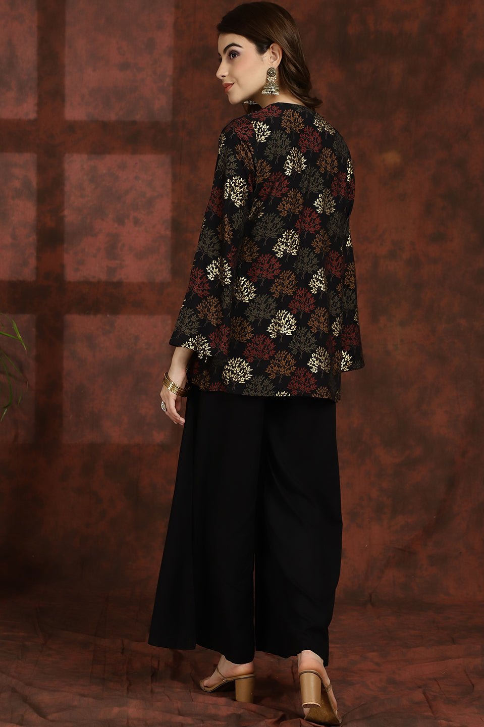Back view of model styling black 3-piece co-ord outfit