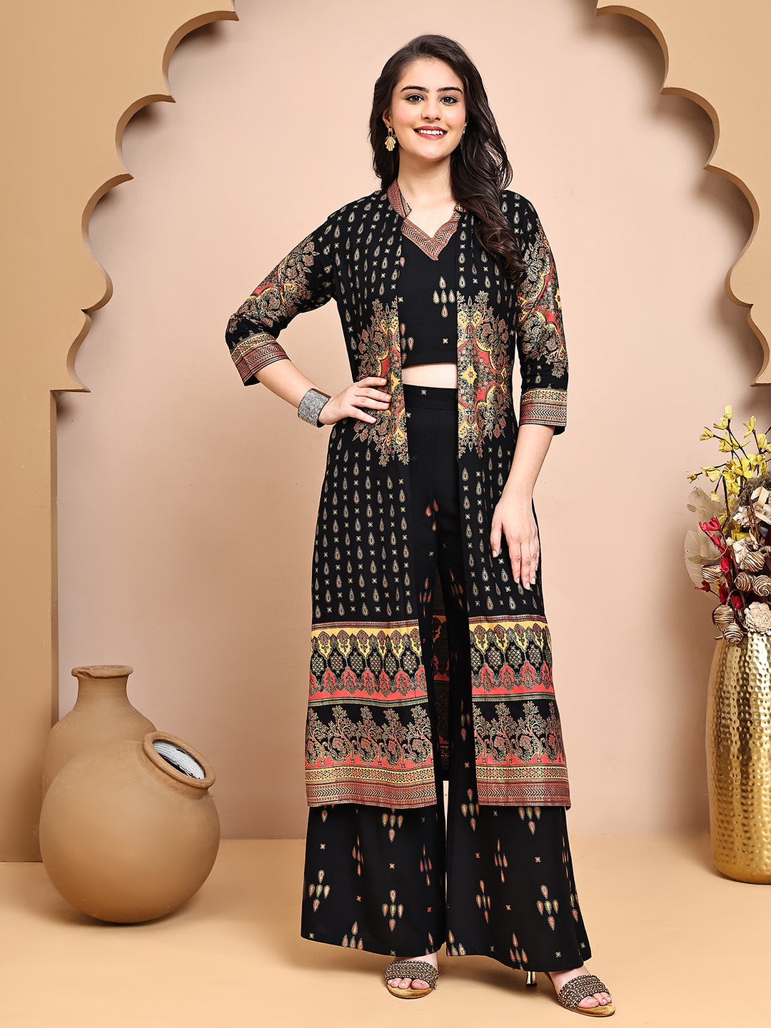 Woman wearing black ethnic print co-ord set with a jacket (front view)

