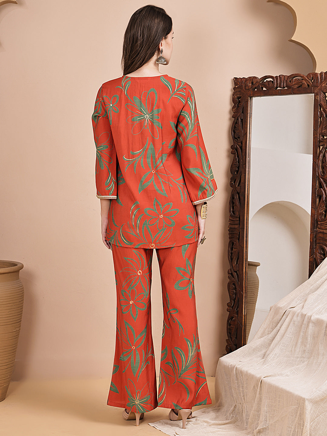 Back view of model styling orange co-ord outfit