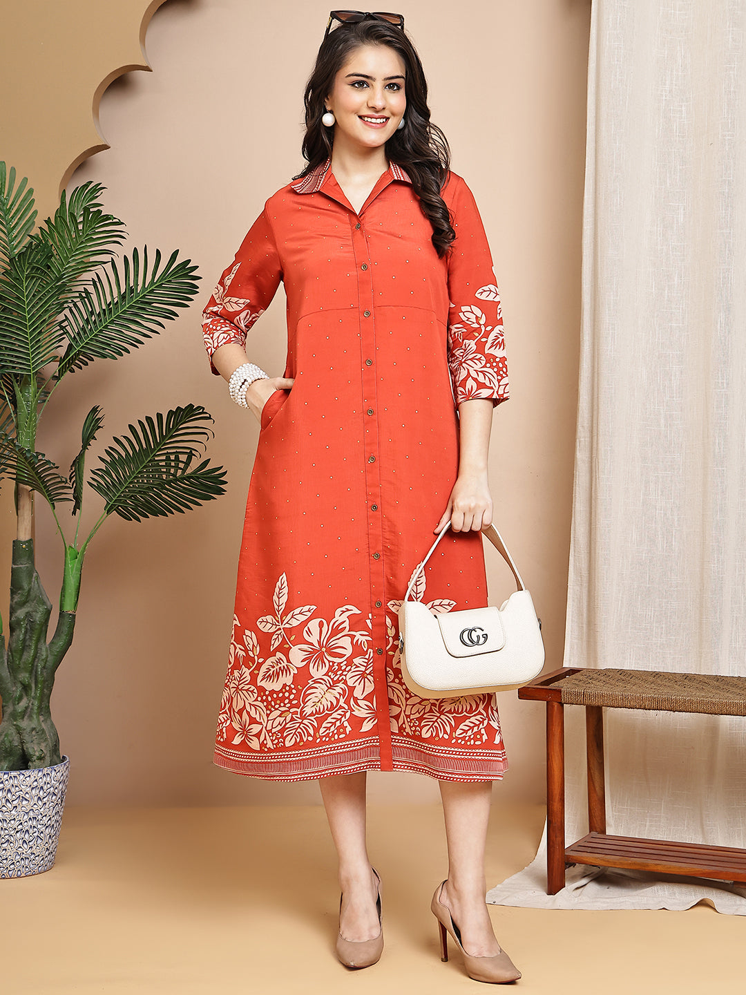 Woman wearing orange floral printed dress