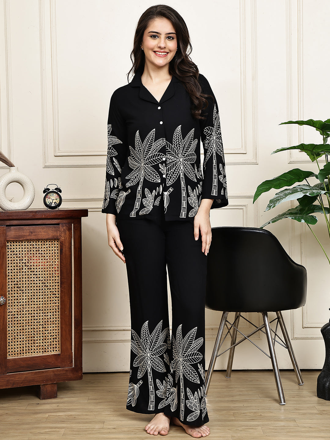 Woman wearing a black abstract print night suit 