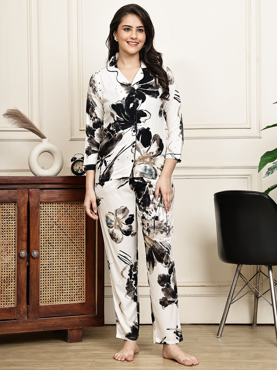 Woman wearing a black floral print night suit 