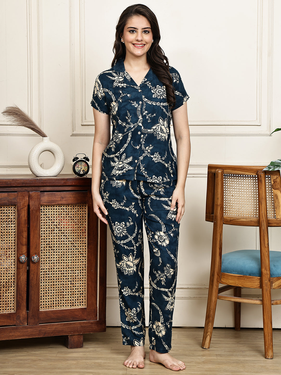 Woman wearing a navy blue floral night suit 