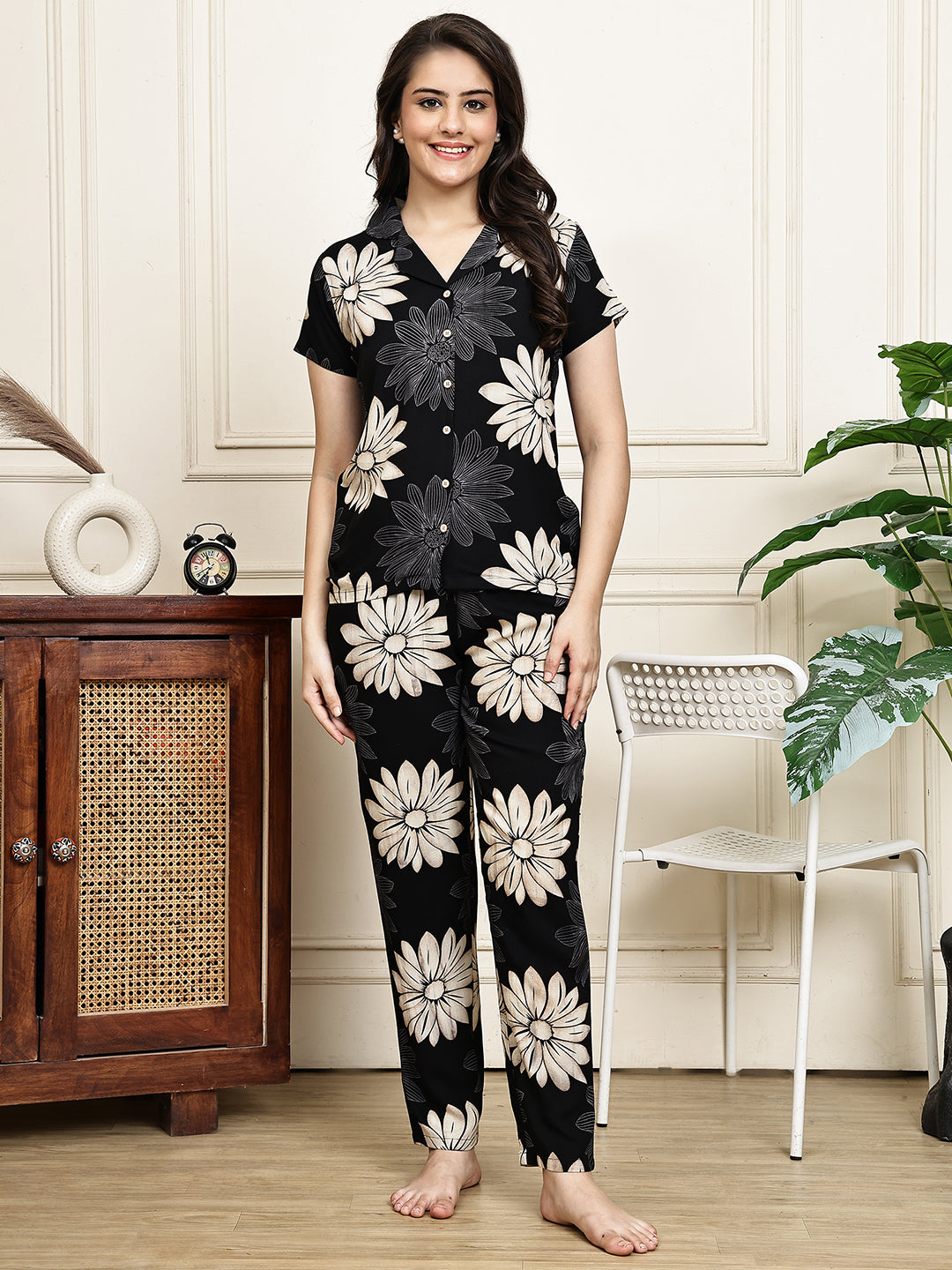Woman wearing a black floral print night suit 