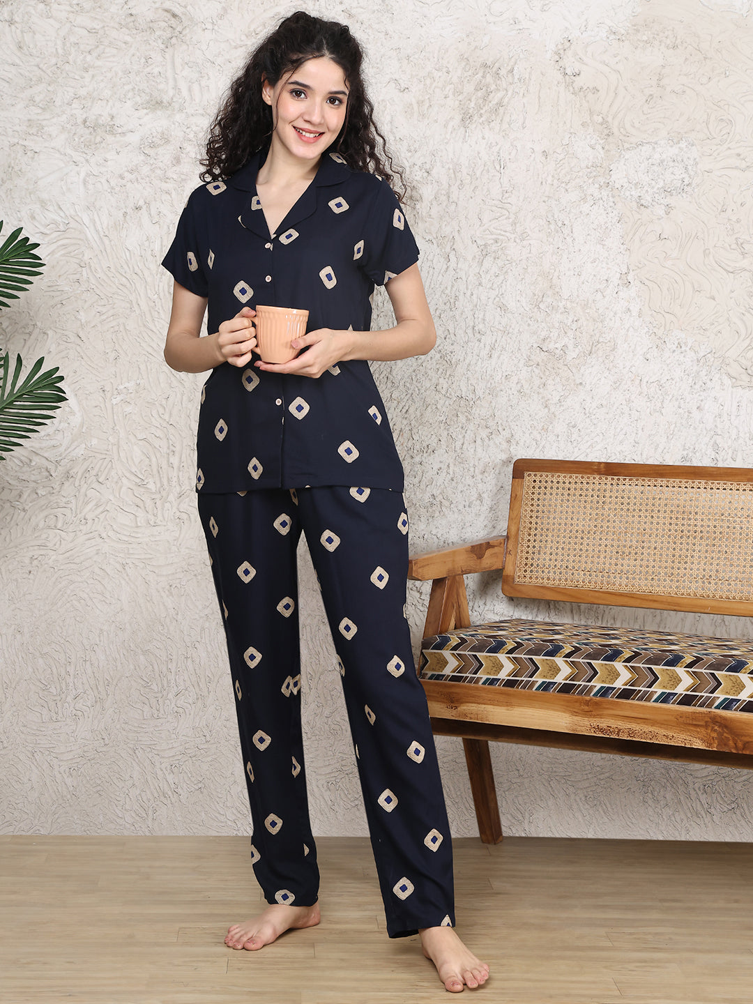 Woman wearing navy blue abstract print night suit