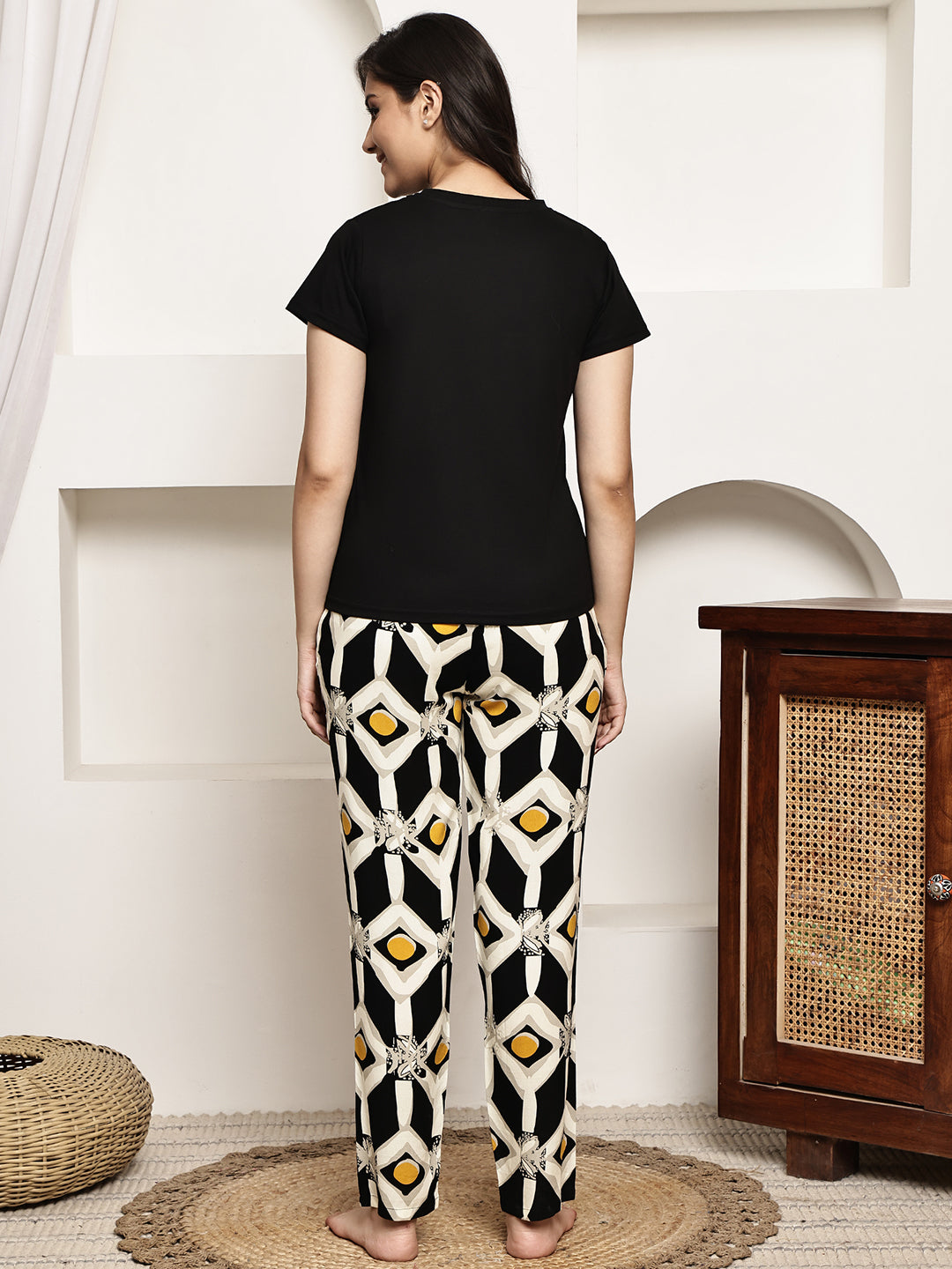 Back view of a model in the black abstract printed night suit
