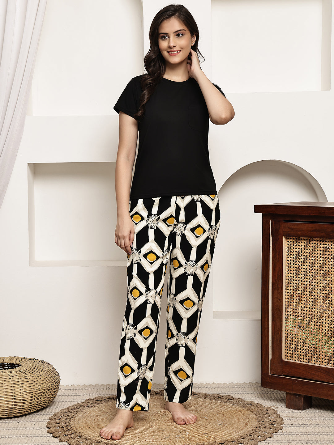 Woman wearing a black abstract print night suit 