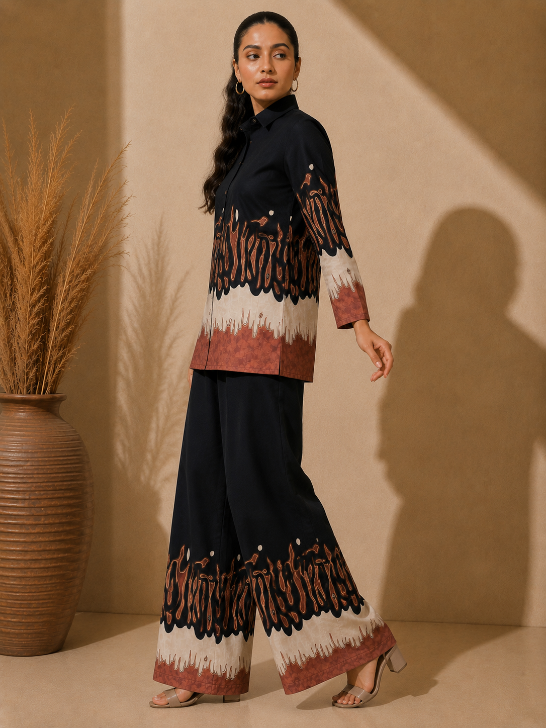 Woman in Black Abstract Printed co-ord set, side profile, shirt and pants