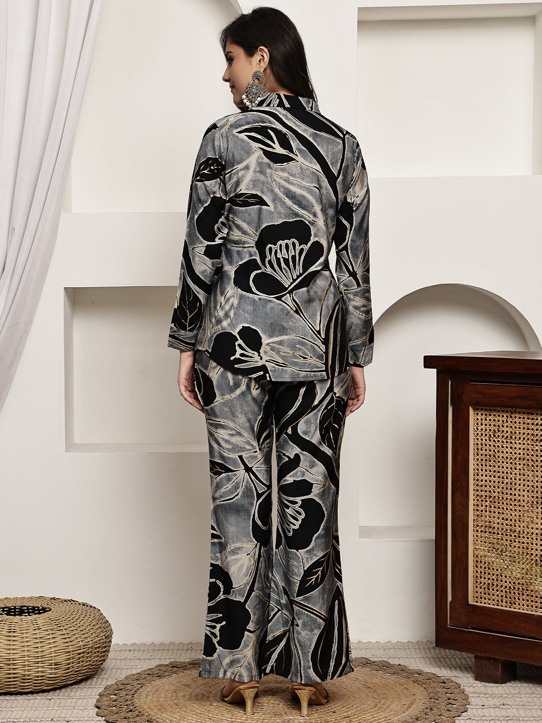 Side view of woman wearing the elegant black floral outfit


