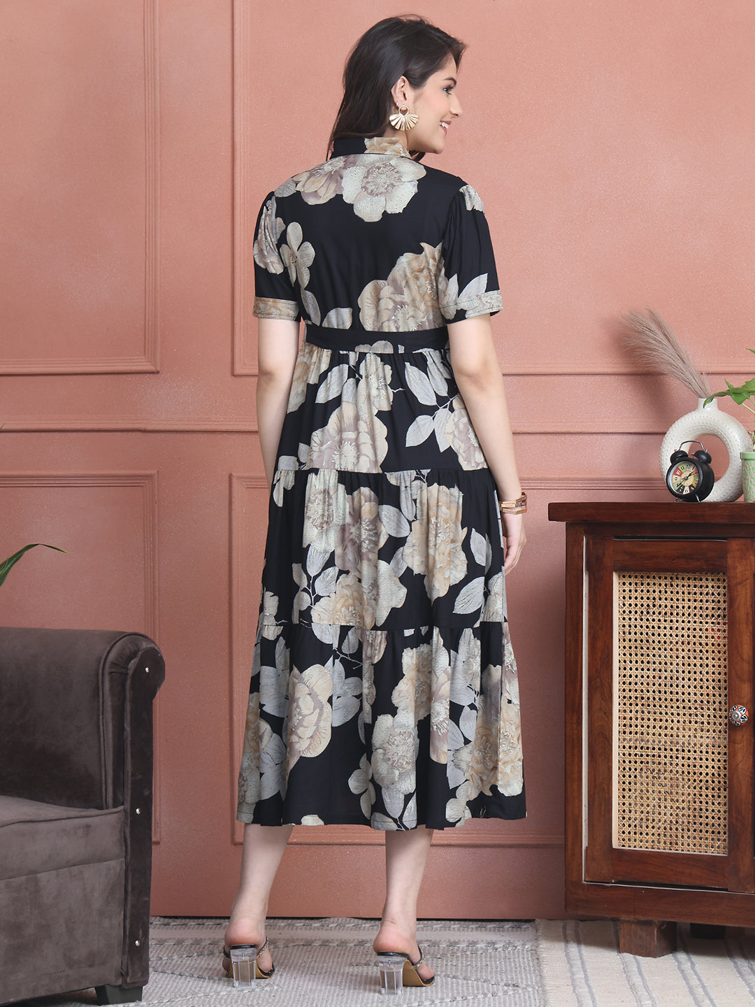 Back view of model in black printed dress