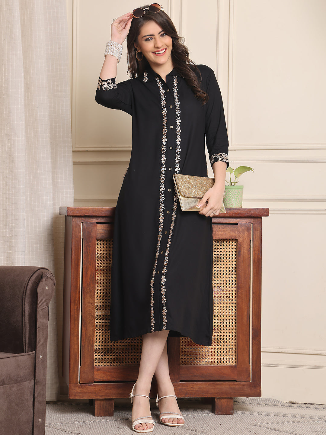 Woman wearing black embroidered printed dress