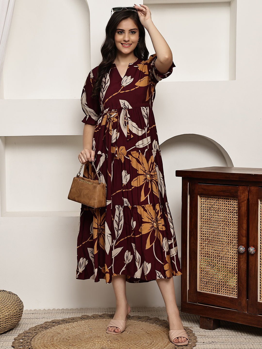 Woman wearing maroon floral printed dress