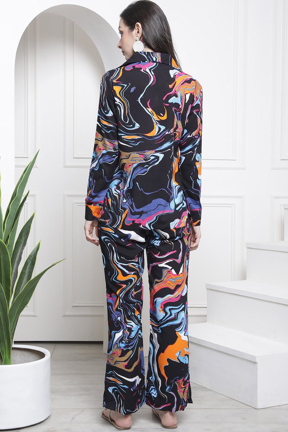 Back view of model styling black co-ord outfit